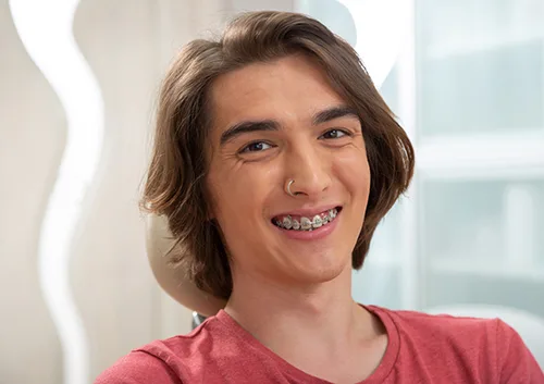 Happy brown-eyed young man in a red T-shirt