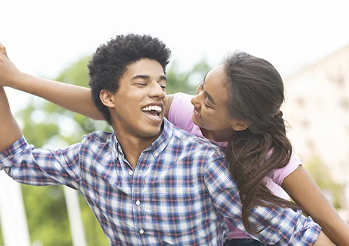 Happy young couple having fun and laughing together outdoors
