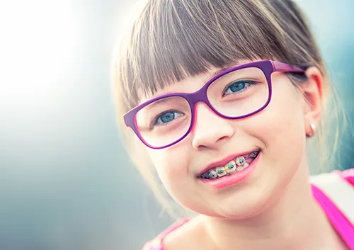 Girl. Teen. Pre teen. Girl with glasses. Girl with teeth braces. Young cute caucasian blond girl wearing teeth braces and glasses