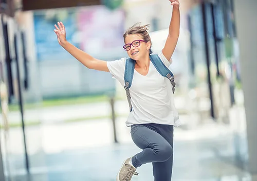 Schoolgirl with bag, backpack. Portrait of modern happy teen sch