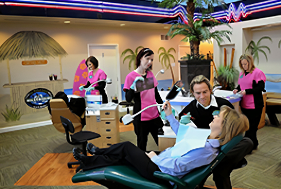 Group fitness class at orthodontics office with participants on exercise equipment in bright studio.