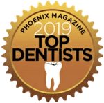 Phoenix Magazine 2019 Top Dentists gold award badge with tooth icon
