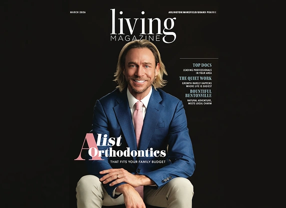 Man in blue blazer seated for magazine cover featuring orthodontics article.